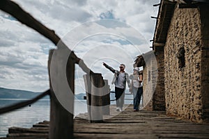 Joyful couple on vacation exploring rustic waterfront together