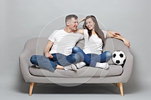 Joyful couple woman man football fans in white t-shirt cheer up support favorite team with soccer ball, hugging isolated