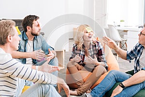 Joyful delighted group of office workers playing a game