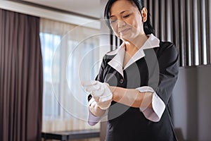 Joyful delighted hotel maid preparing to work