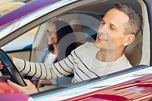 Joyful delighted man driving the car