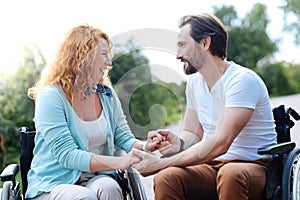 Joyful disabled couple spending time in the park