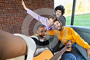 Joyful Diverse Friends Taking Selfie with Guitar Indoors