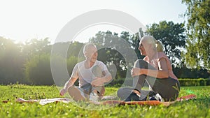 Joyful elderly couple starting doing physical exercises in the park