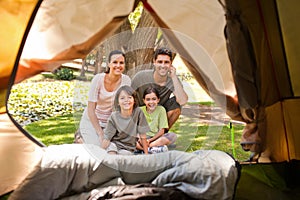 Joyful family camping in the park