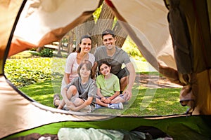 Joyful family camping in the park