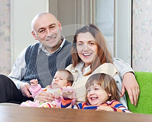 Joyful family of four at their home