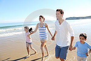 Joyful family having fun on the beach