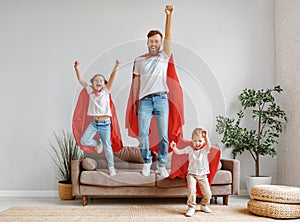Joyful father and children having fun at home