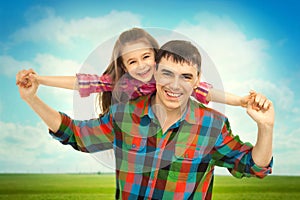 Joyful father with daughter on shoulders