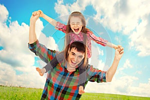 Joyful father with daughter on shoulders