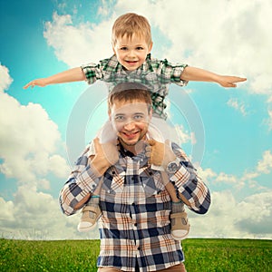 Joyful father with son on shoulders