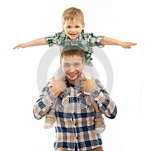 Joyful father with son on shoulders