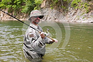 Joyful Fisherman catches of salmon