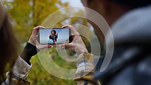 Joyful friends videocalling smartphone outdoors closeup. Happy travel girl wave