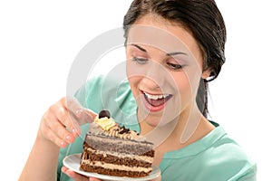 Joyful girl eating tasty piece of cake