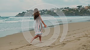 Joyful girl having fun at sea beach. Happy teenager resting at coastline.