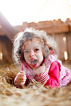 Joyful Girl in Hay Laughing