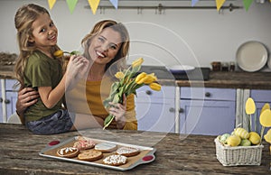 Joyful girl helping her mother with holiday preparations