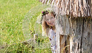 Joyful girl peeking out of beehive