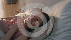 Joyful girl resting bed in morning sunlight closeup. Happy woman waking up early