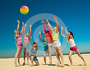 Joyful girls playing volleyball