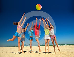 Joyful girls playing volleyball