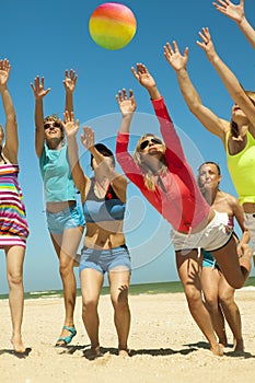 Joyful girls playing volleyball