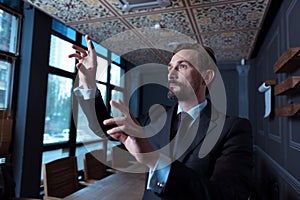 Joyful good looking man standing in the conference hall