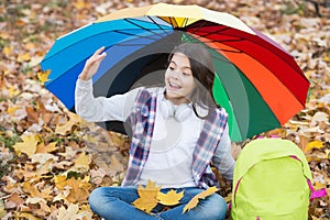 Joyful greeting. autumn kid under colorful umbrella. feel the inspiration. happy childhood. back to school. girl with