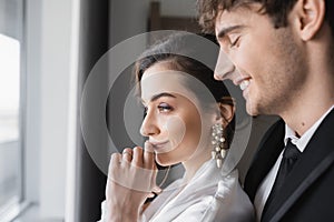 joyful groom in classic black suit