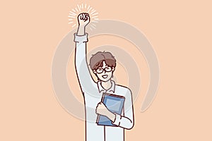 Joyful guy student with textbook in hand makes winning gesture after winning olympiad. Vector image photo