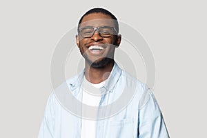 Joyful happy african american young man in eyeglasses portrait.