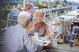 Joyful happy aged couple going out together