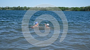 Joyful happy boy and girl play and splashed together in the water