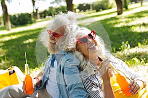 Joyful happy couple having drinks