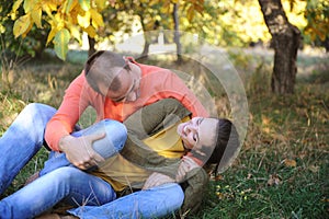 Joyful happy love couple have a fun in autumn park