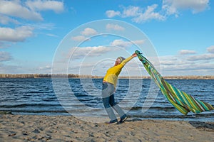 Joyful happy woman having fun, catches the wind, playing with co