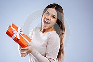 Joyful happy woman holding a gift box