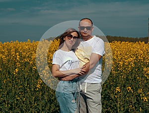 Joyful and happy woman and man on a rapeseed field