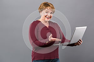 Joyful happy woman showing her laptop