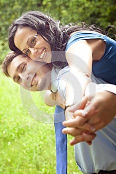 Joyful happy young couple playing outdoor