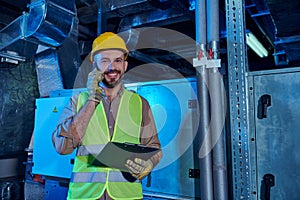 joyful hardworking technician in helmet looking