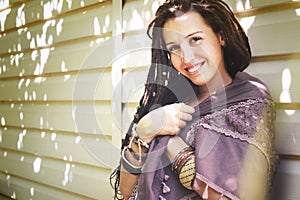 Joyful hippie style woman with dreadlocks portrait, sunny summer outdoor, vintage colors