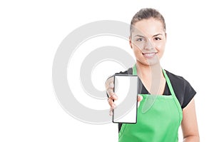 Joyful hypermarket employee holding smartphone photo
