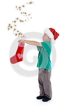 Joyful kid releasing stars from Christmas stocking
