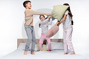 joyful kids having pillow fight while
