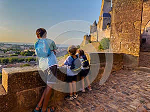 Joyful kids overlook Carcassonne castle at sunset enjoy panorama