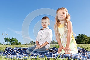 Joyful kids sitting on blanket