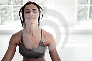 Joyful lady listening to music during meditation